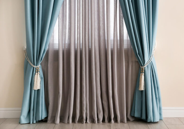 Light grey pleated blackout curtains with white sheer layer in a modern living room