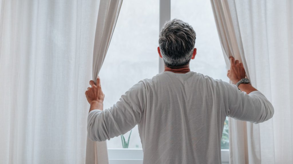 Elderly person opening easy curtains