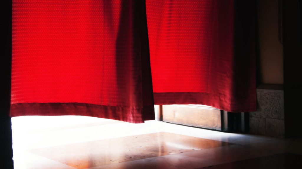 Why are fire-retardant curtains needed in Abu Dhabi?